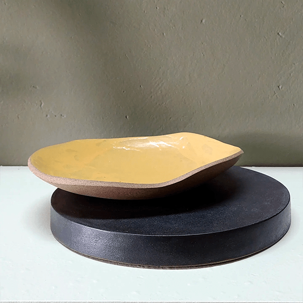 Centro de mesa cerâmica Açafrão elaborado em argila capuccino com esmalte preto fosco e amarelo brilho.